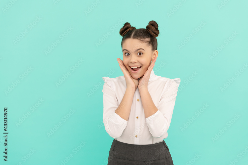Happy teenage girl back to school touching face skin blue background, skincare Happy teenage girl back to school touching face skin blue background, skincare