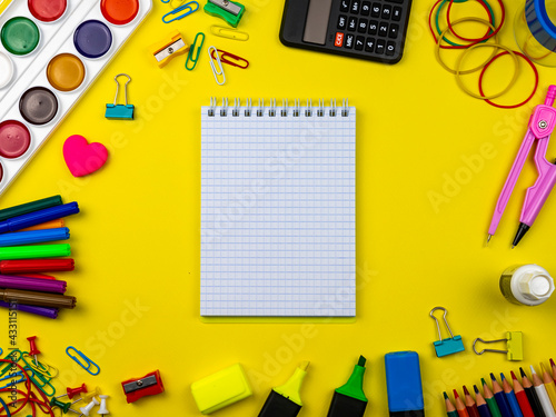 School supplies on a bright yellow background. Copy Space. Stationery on a yellow table. School concept. Back to school. Paints, pencils, rulers and other school items for study