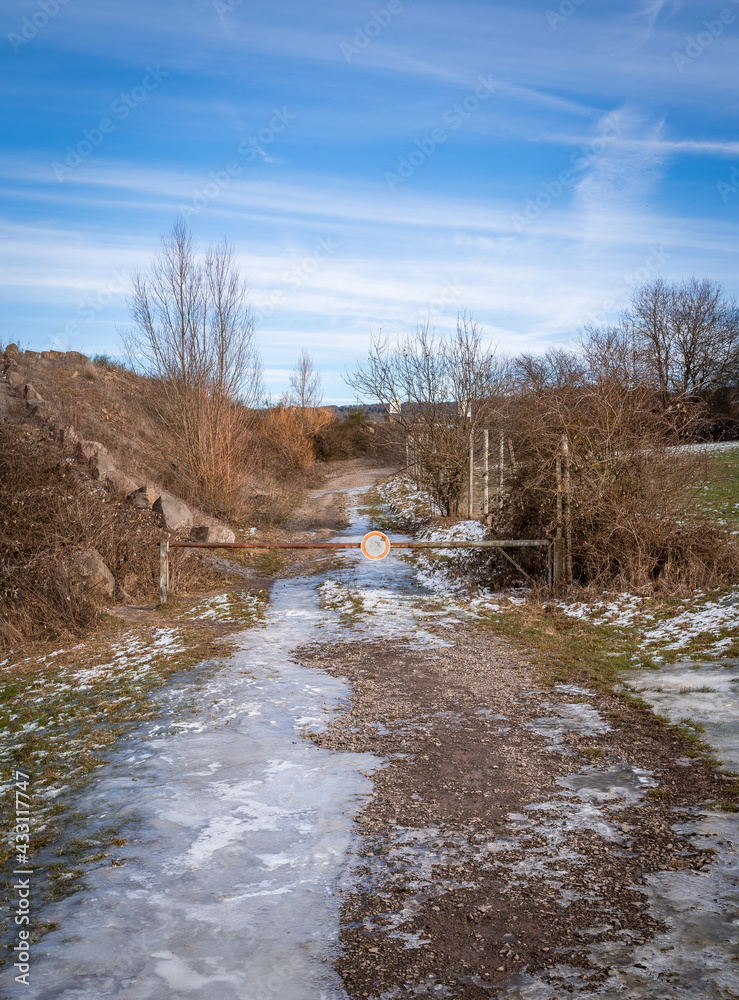 Pathway with ice and blue cloudy sky in the forest Pathway with ice and blue cloudy sky in the forest