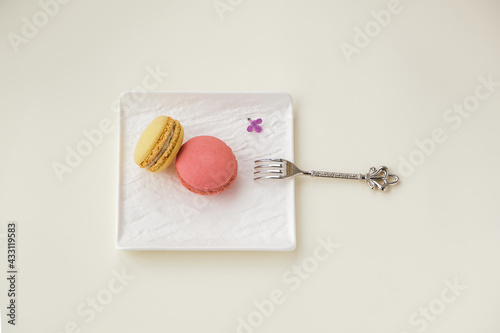 Macaroons on plate on ligtht background. Top view. photo