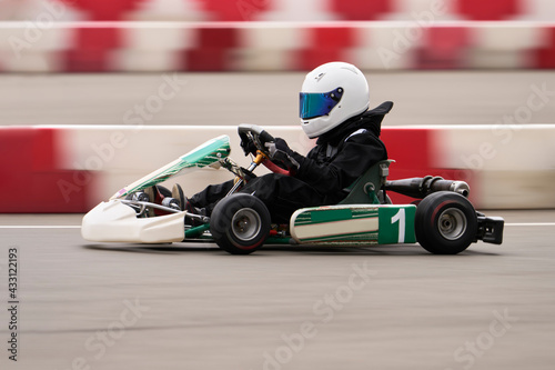 Sports car racing at high speed on the track. Side view. Selective focus. Copy space. Blur in motion. © ROMAN DZIUBALO