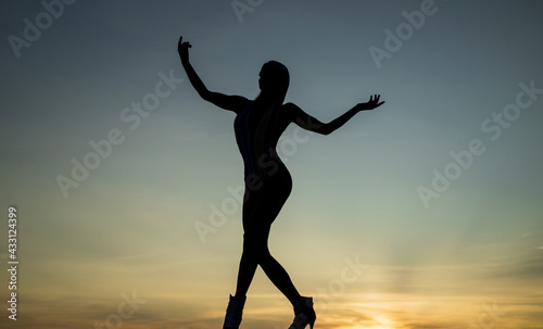 Rise of inspiration. Woman silhouette on evening sky. Inspirational figure. Inspiration
