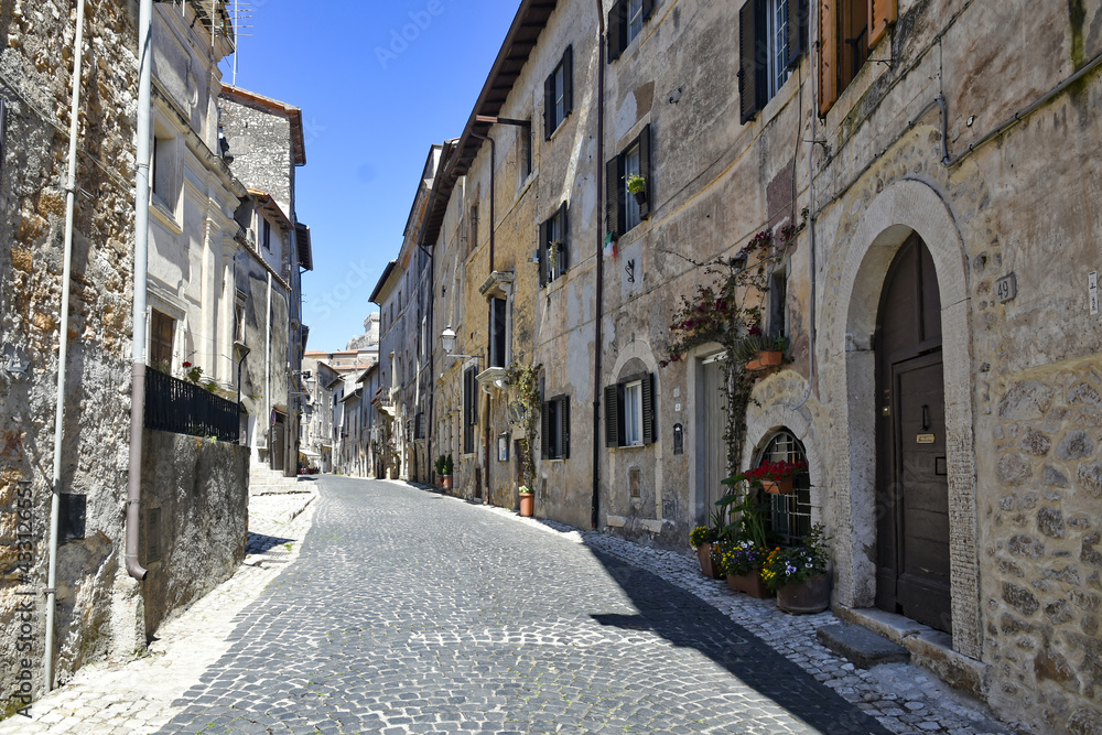 Sermoneta, Italy, 05/10/2021. A street between old medieval stone buildings in the historic town.