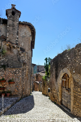 Sermoneta, Italy, 05/10/2021. A street between old medieval stone buildings in the historic town. photo