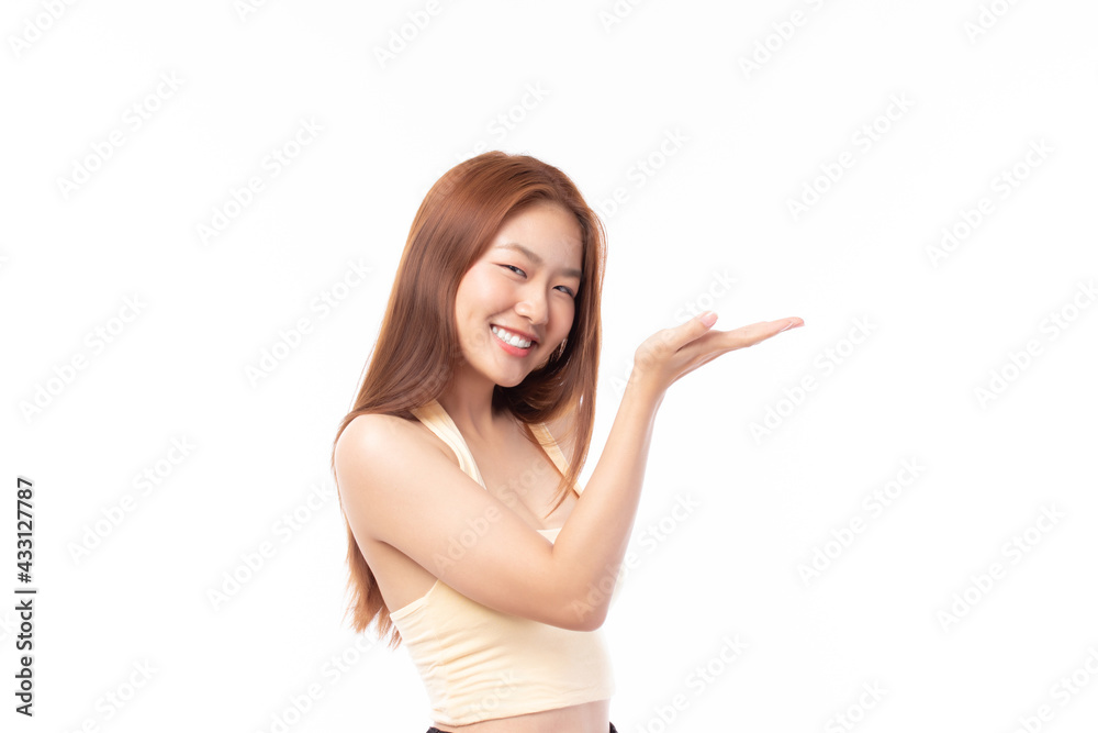 Beautiful Asian woman wearing casual clothes smile and pointing finger at copy space isolated on white background studio portrait. Beautiful Asian woman wearing casual clothes smile and pointing finger at copy space isolated on white background studio portrait.