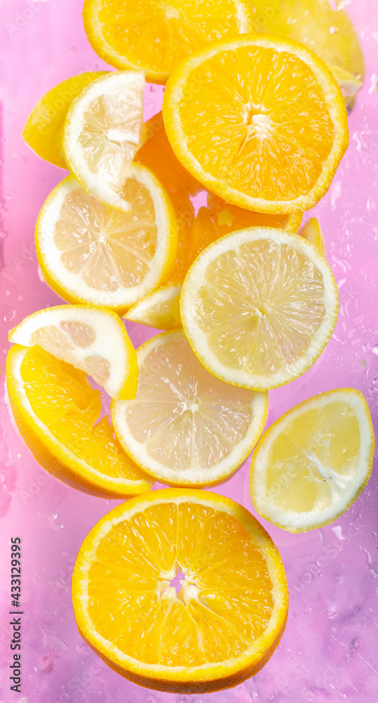 Fresh oranged and lemons on a pink background. Fresh oranged and lemons on a pink background.