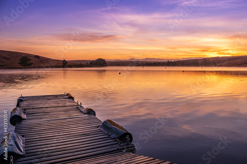 Sunrise view of a still, silent dam with boat jetty’s in the foreground,  Club Elani Resort, Cape Town, South Africa photo