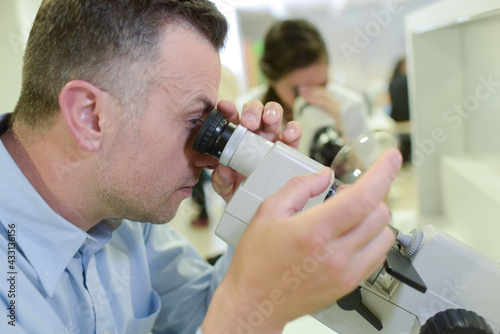 a man using a microscope