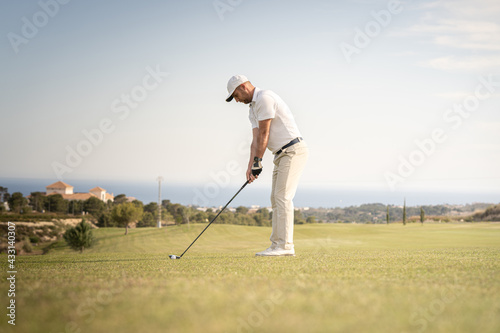 Golfer getting ready to hit the ball.