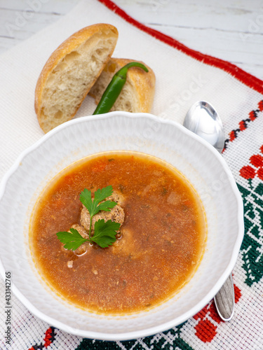 romanian dish ciorba de perisoare or meat balls soup served with hot pepper photo