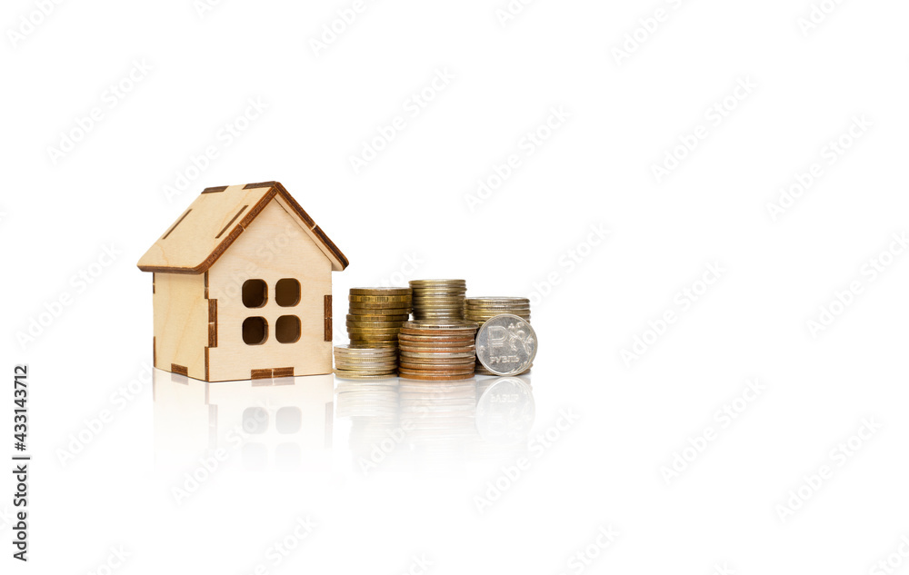 wooden house and towers from coins on a white background. russian rubles wooden house and towers from coins on a white background. russian rubles