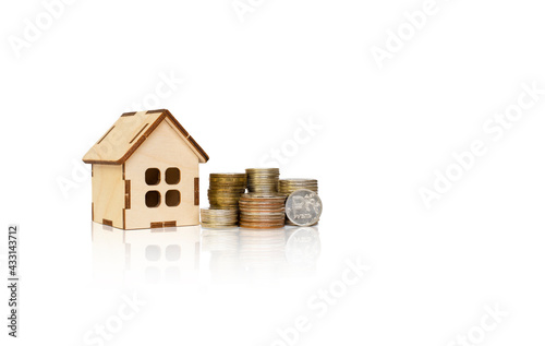 wooden house and towers from coins on a white background. russian rubles