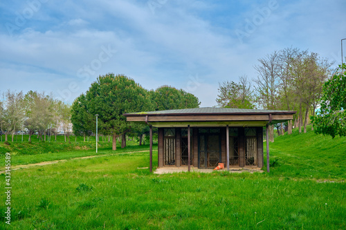 Small vintage house building inside the green grass. House made of wooden material there are many green trees during spring time in Bursa.