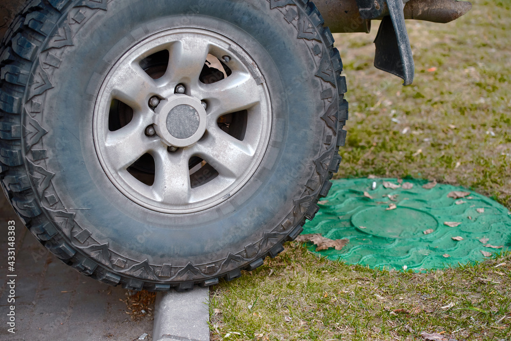Parking with traffic violations, poor parking, car wheel ran over the curb in front of the green lawn. Lawn parking offences. Overspill parking. Parking with traffic violations, poor parking, car wheel ran over the curb in front of the green lawn. Lawn parking offences. Overspill parking.