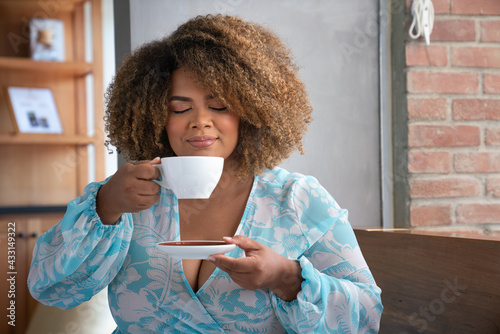 hispanic woman drinking coffee