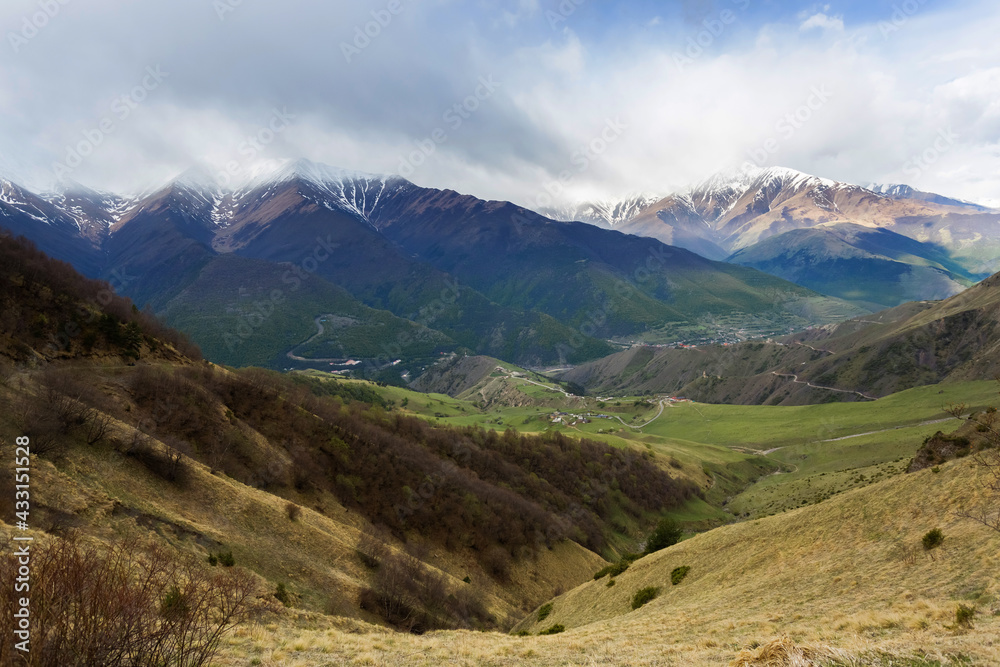 Panoramic view of Ingushetia, Russia. Mountain landscape, rocks, plateau and sky. Gorges and peaks. Mountain climbing. Tourist adventure.