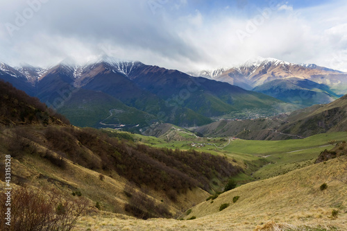 Panoramic view of Ingushetia, Russia. Mountain landscape, rocks, plateau and sky. Gorges and peaks. Mountain climbing. Tourist adventure.