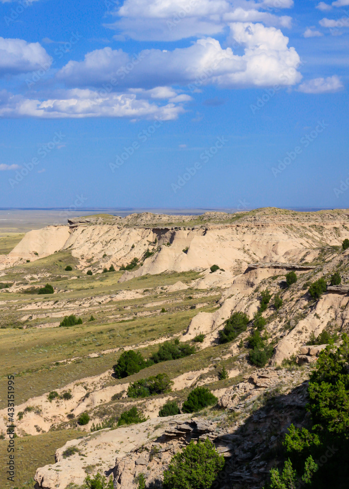 Pawnee Buttes in Pawnee National Grasslands, Great Plains of northeastern Colorado with late afternoon clouds forming against the blue sky
