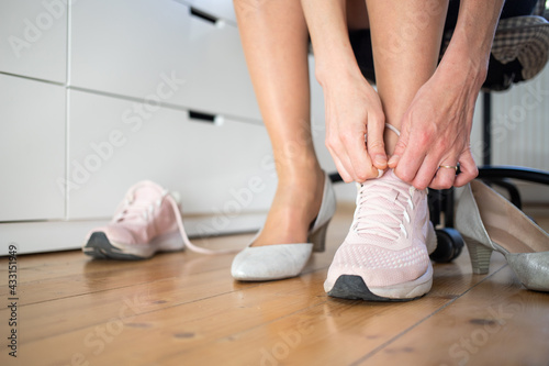 business woman changing to sports shoes