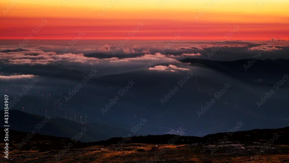 Wind turbines at sunset above clouds. View from Torre mountain peak of Serra da Estrela in Portugal. Wind turbines at sunset above clouds. View from Torre mountain peak of Serra da Estrela in Portugal.