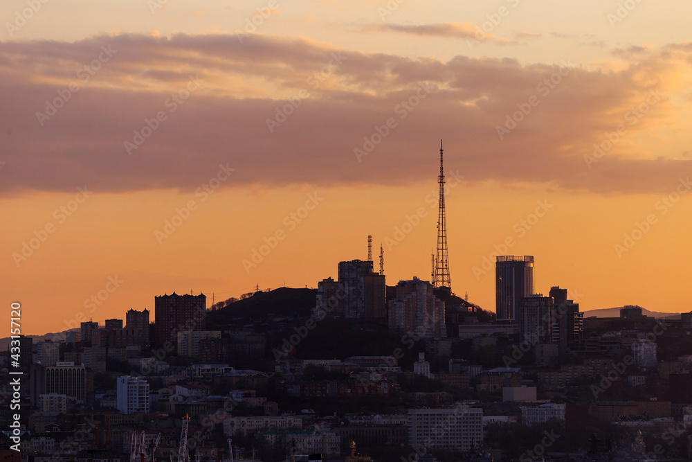 April, 2017 - Vladivostok, Russia - Dawn in Vladivostok. A television tower stands on a hill in Vladivostok at dawn. A silhouette of the Vladivostok hills.