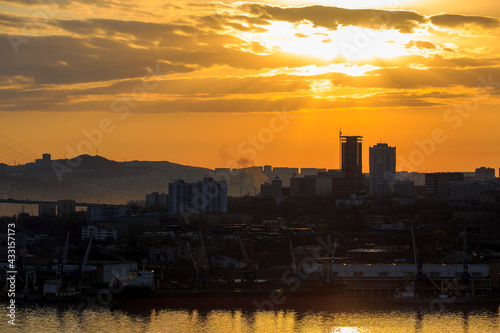 April, 2017 - Vladivostok, Russia - Dawn in Vladivostok. Silhouettes of the sea facade of Vladivostok during dawn.