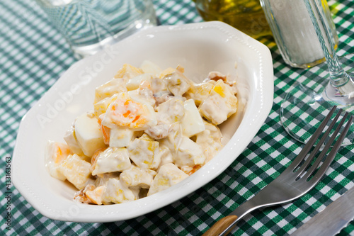 Delicious salad with chicken fillet, pineapple and eggs, dressed with yogurt sauce