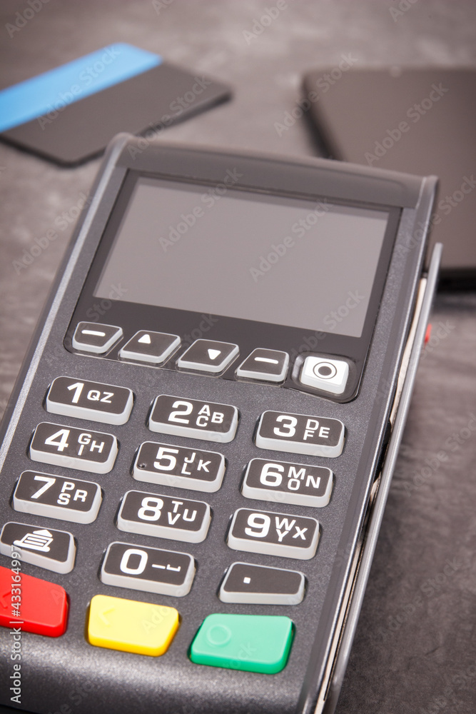 Payment terminal with credit card and mobile phone. Cashless paying for shopping. Finance concept Payment terminal with credit card and mobile phone. Cashless paying for shopping. Finance concept