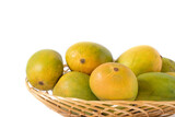 indian mangos in a basket on a white background in close up view
