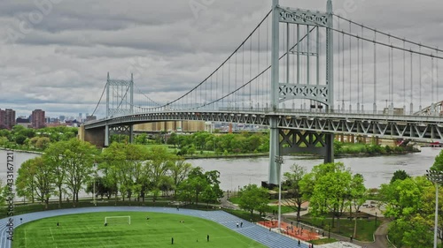 The Robert F Kennedy bridge filmed from Astoria Queens with East River on a cloudy day.