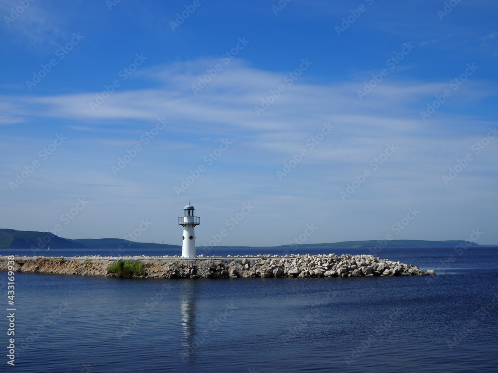 beautiful landscape with a view of the Small white lighthouse on a shore of Volga river