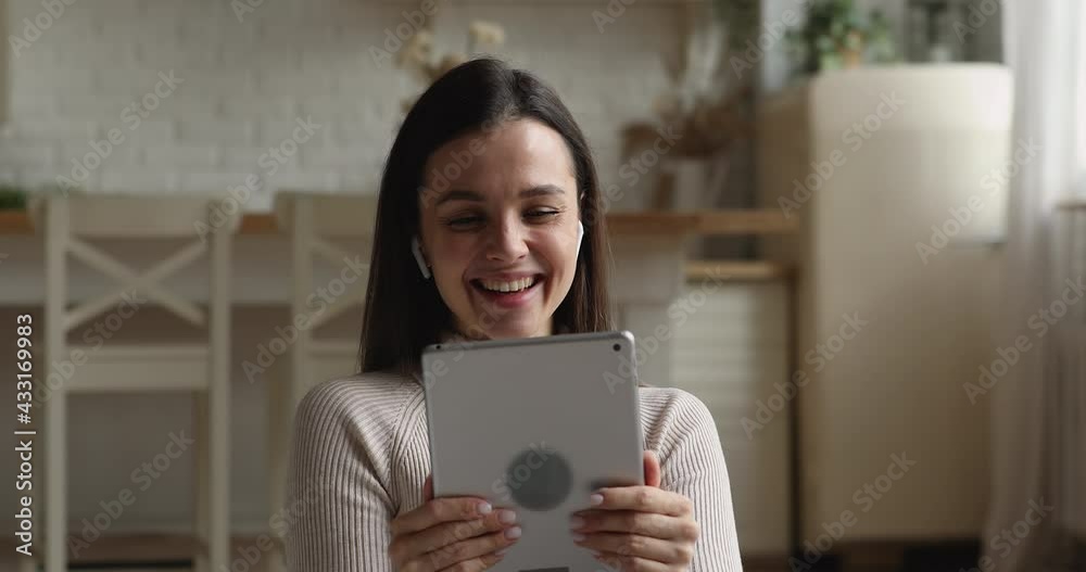Attractive young woman rest on sofa hold tablet device greeting friend start videocall communication, enjoy pleasant talk use application, internet connection, modern device. Video call event concept Attractive young woman rest on sofa hold tablet device greeting friend start videocall communication, enjoy pleasant talk use application, internet connection, modern device. Video call event concept