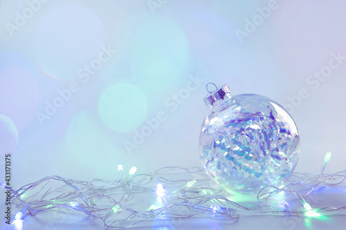 blue christmas ball and lights on blurred background