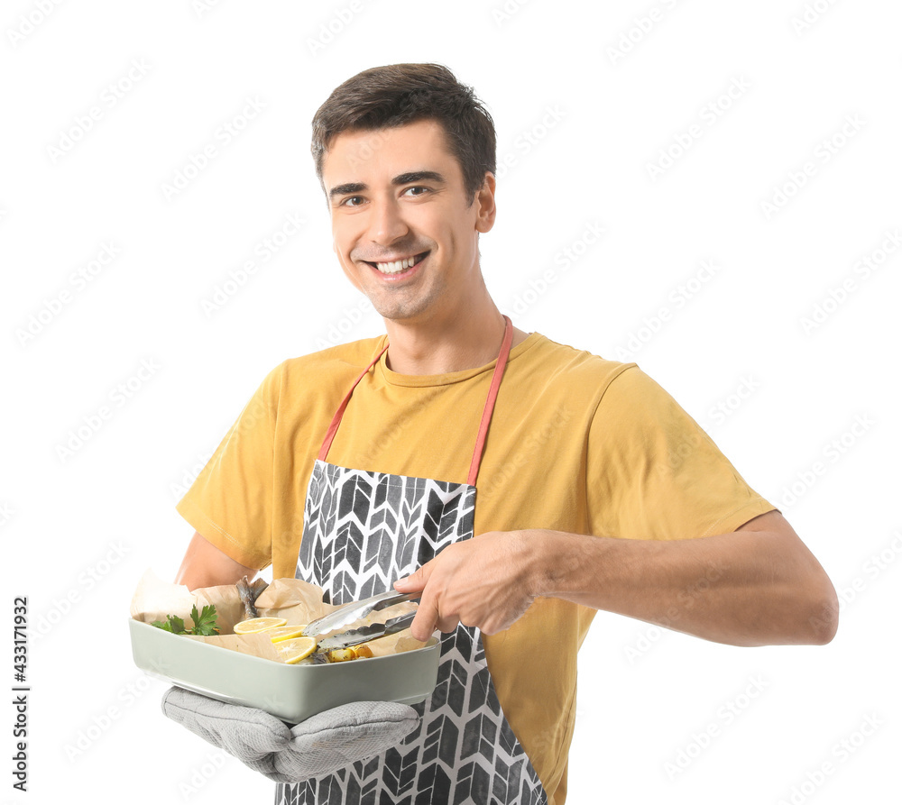 Young man with baking dish on white background Young man with baking dish on white background