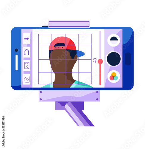 Broadcast from phone fixed to monopod isolated. Smartphone photo editing app. Video recording of handsome dark skinned young man in cap. Boy is posing for shooting, blogger story maker preparing post