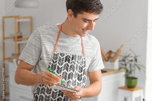 Young man with notebook in ...