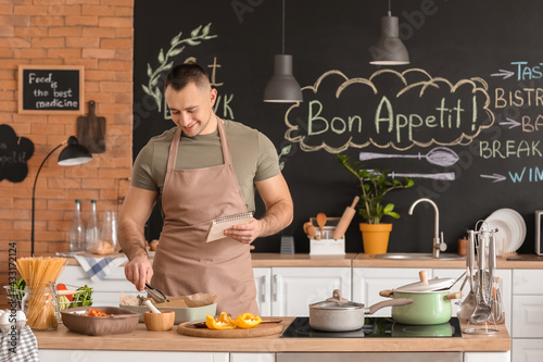 Young man cooking in kitchen