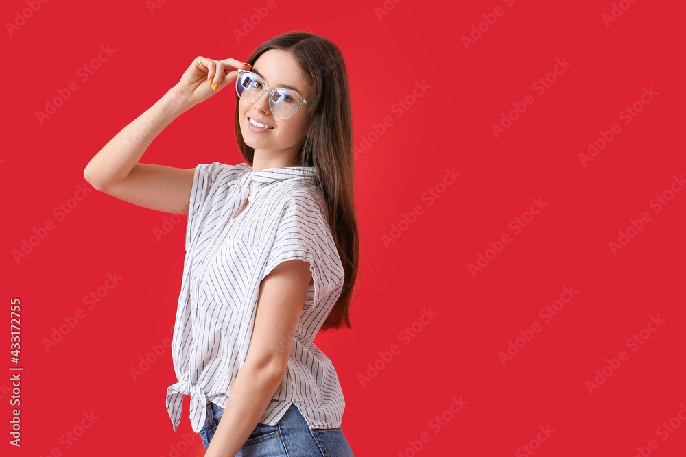 Young woman wearing eyeglasses on color background Young woman wearing eyeglasses on color background