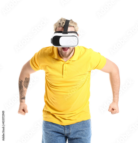 Young man with VR glasses on white background © Pixel-Shot