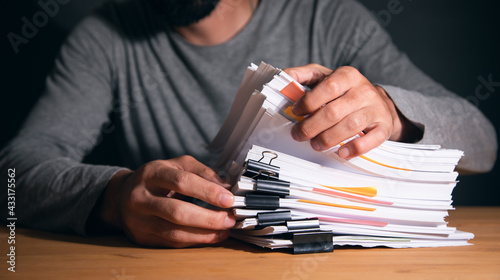 man working in stack of paper