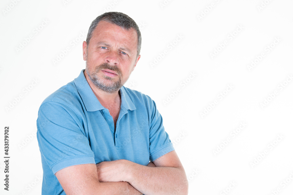 handsome mature man arms crossed on white background aside copy space in blue shirt handsome mature man arms crossed on white background aside copy space in blue shirt