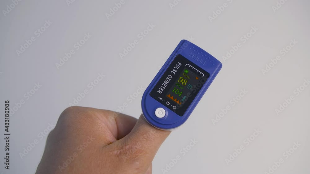 Close up of hand with heart rate monitors for measuring oxygen level and heart rate. 4K footage. Close up of hand with heart rate monitors for measuring oxygen level and heart rate. 4K footage.