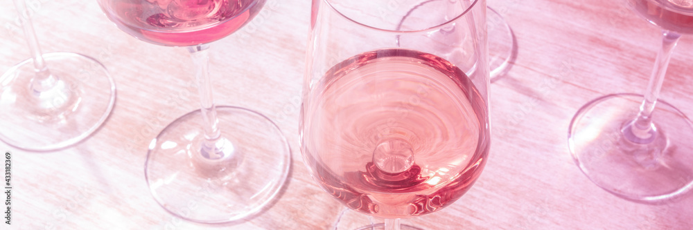 Rose wine panorama, toned in pink. Various wineglasses at a tasting - obrazy, fototapety, plakaty 
