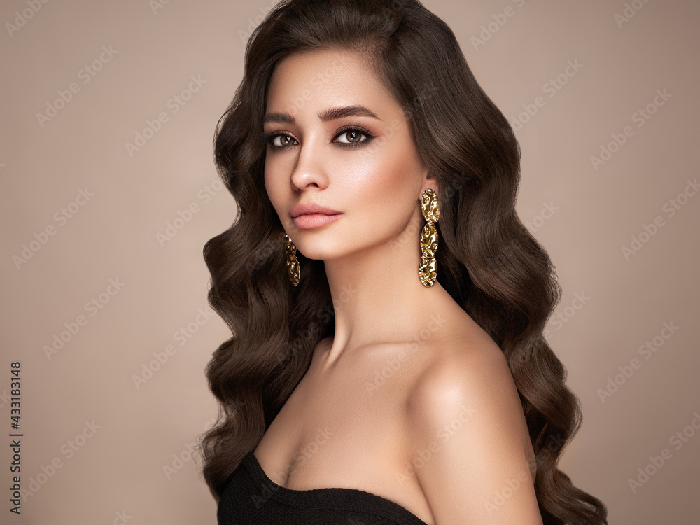 Brunette girl with perfect makeup. Smiling beautiful model woman with long curly hairstyle. Care and beauty hair products. Brunette girl with perfect makeup. Smiling beautiful model woman with long curly hairstyle. Care and beauty hair products.