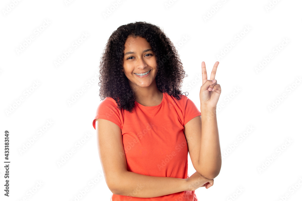 Close up of smiling little african american kid girl wearing red t-shirt looking at camera isolated on a white background Close up of smiling little african american kid girl wearing red t-shirt looking at camera isolated on a white background