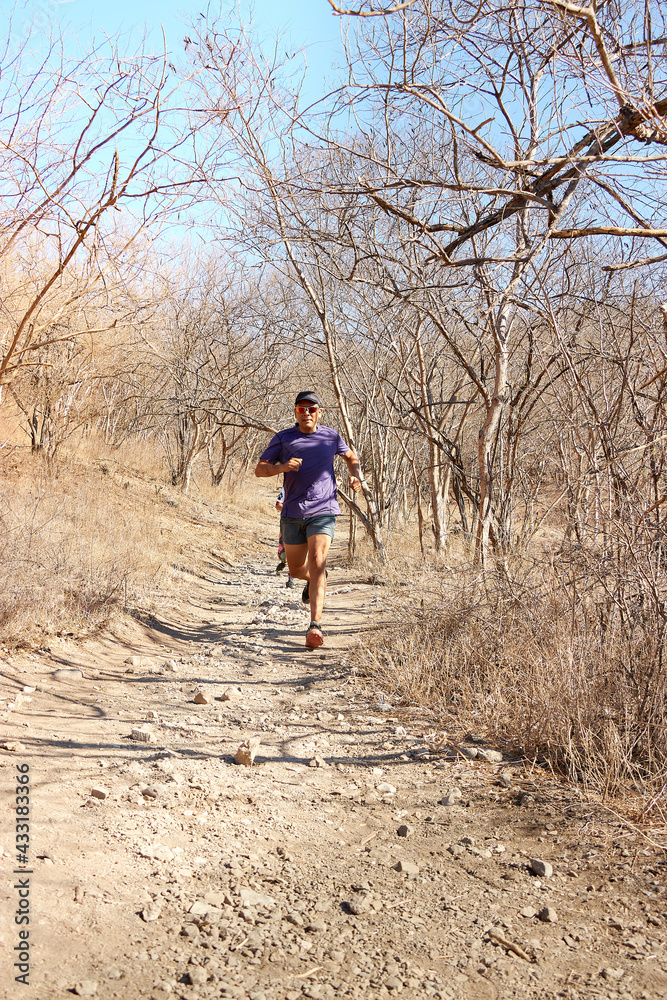 Middle-aged man running and hiking