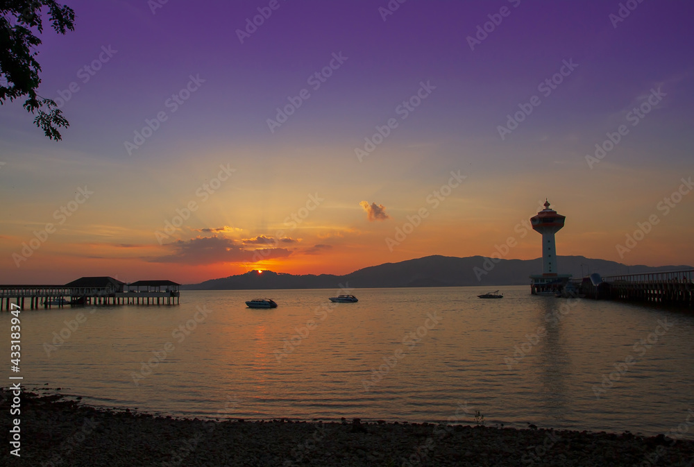 Beautiful scenery sunset landscape,Silhouette Scene of Custom Pier and Lighthouse in Ranong, Thailand