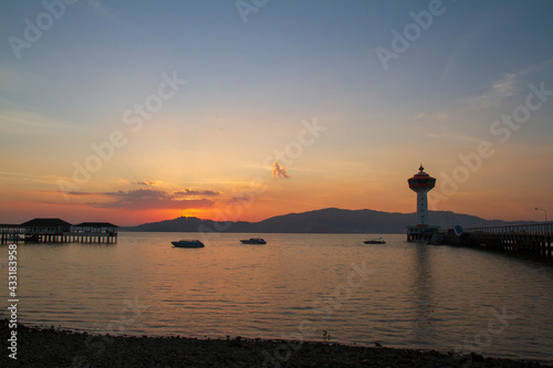 Beautiful scenery sunset landscape,Silhouette Scene of Custom Pier and Lighthouse in Ranong, Thailand