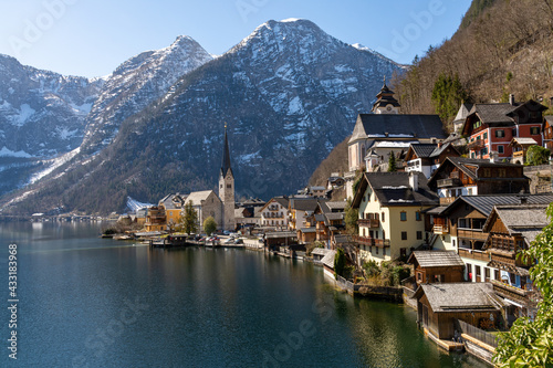 Hallstatt, Austria - March 31, 2021 View of Hallstatt with snow-capped mountains in the background