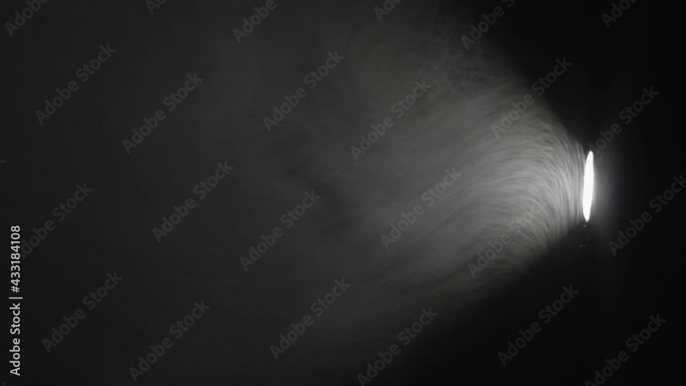 Dust playing in the projector light beam in the dark